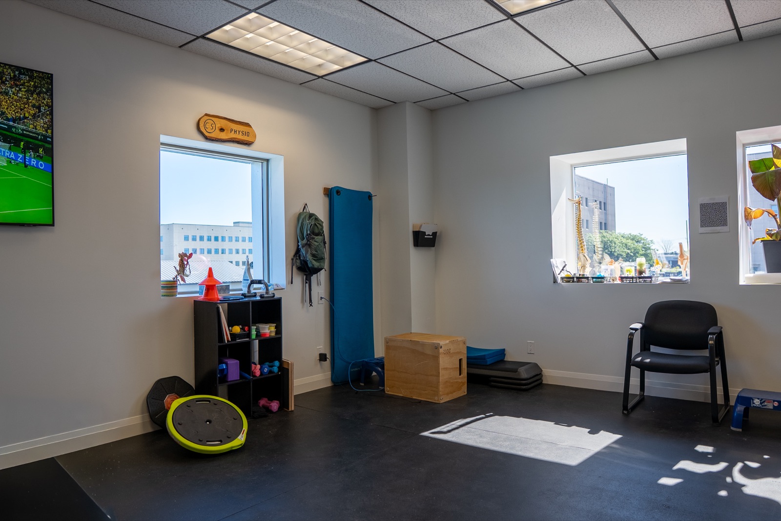 Open rehab studio with natural light, storage and training equipment